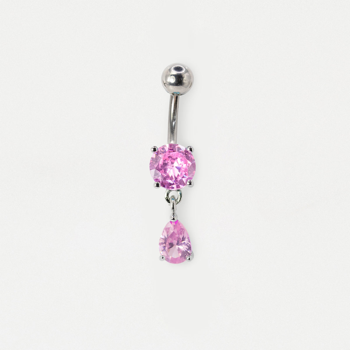 A Steel belly bar featuring a claw-set round gemstone top element and a matching dangling pear-cut teardrop charm available in rose quartz by Kingsley Ryan Wholesale