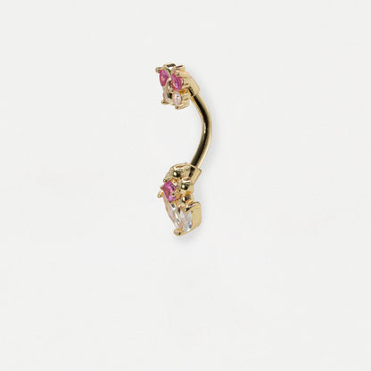 Side profile showing a belly bar in gold on a white grey background with pink and clear gemstones on a butterfly and flower design