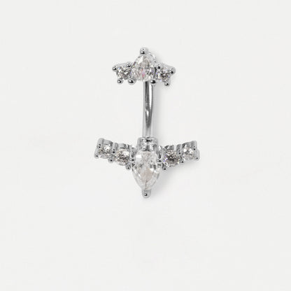 A silver-toned belly button ring featuring a central teardrop-shaped clear gemstone and smaller clear stones arranged in a decorative top and side settings, shown on a plain light background.