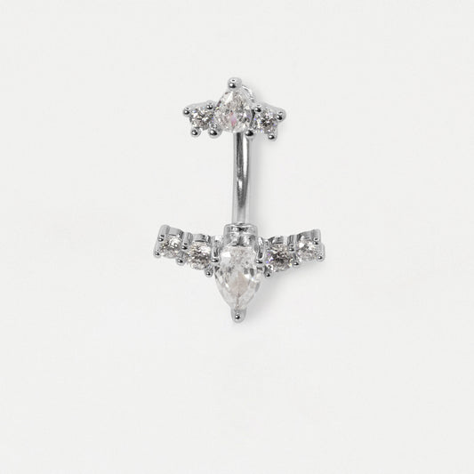 A silver-toned belly button ring featuring a central teardrop-shaped clear gemstone and smaller clear stones arranged in a decorative top and side settings, shown on a plain light background.