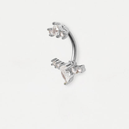 A steel curved barbell belly button piercing adorned with clear faceted gemstones, shown on a plain light gray background.
