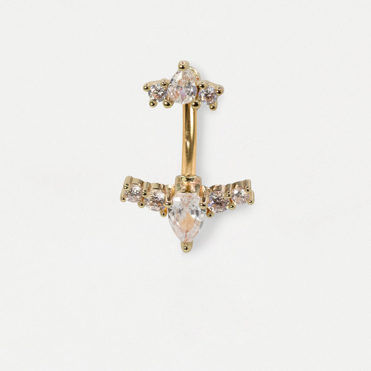 A gold-plated belly button ring featuring a cluster of clear crystals at the top and a larger marquise-cut clear crystal at the bottom, flanked by smaller round crystals on the horizontal bar.