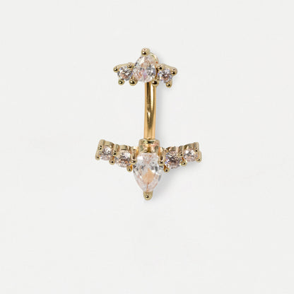 A gold-plated belly button ring featuring a cluster of clear crystals at the top and a larger marquise-cut clear crystal at the bottom, flanked by smaller round crystals on the horizontal bar.
