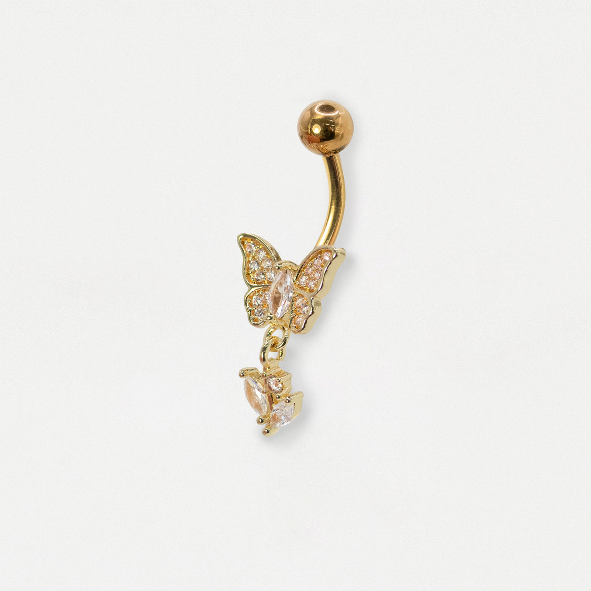 Gold-plated belly button ring with a butterfly and teardrop charm, embellished with clear rhinestones, on a light gray background.