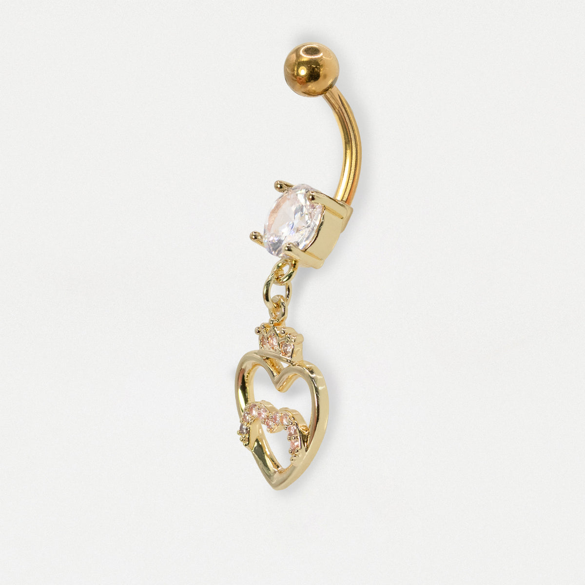 A side view of a Gold PVD Steel navel bar set with a round clear crystal and an open heart dangle dangle topped with a small crown embellished with clear crystal pavé by Kingsley Ryan Wholesale