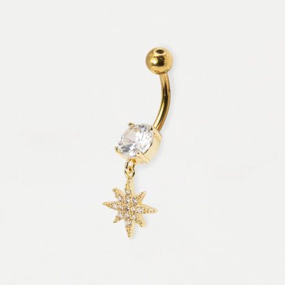 Gold PVD 316 Grade Steel belly bar featuring a claw-set round clear crystal solitaire and a dangling pavé-set Christmas star charm with clear crystals by Kingsley Ryan Wholesale