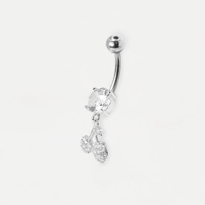 A steel curved barbell belly button ring with a large clear faceted stone and two dangling clear crystal charms, shown on a plain light gray background.