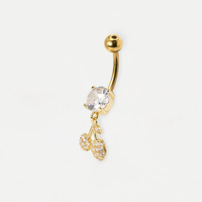 Gold curved barbell belly button ring with a clear faceted gemstone and two dangling cherry charms, shown on a plain white background.