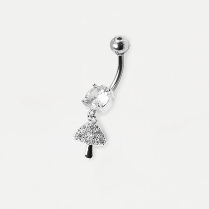 A silver-toned curved barbell belly button ring featuring a clear faceted gemstone and a dangling tree charm, shown on a plain light gray background.