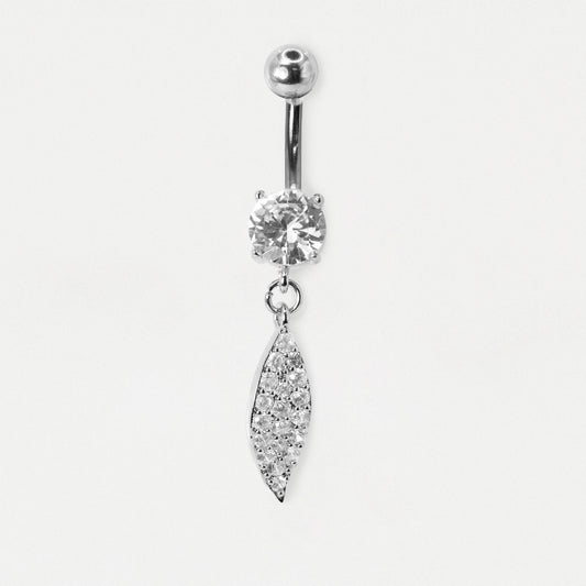 A Steel belly bar featuring a claw-set round clear crystal and a dangling leaf-shaped charm fully pavé-set with clear crystals by Kingsley Ryan Wholesale on a pale grey background