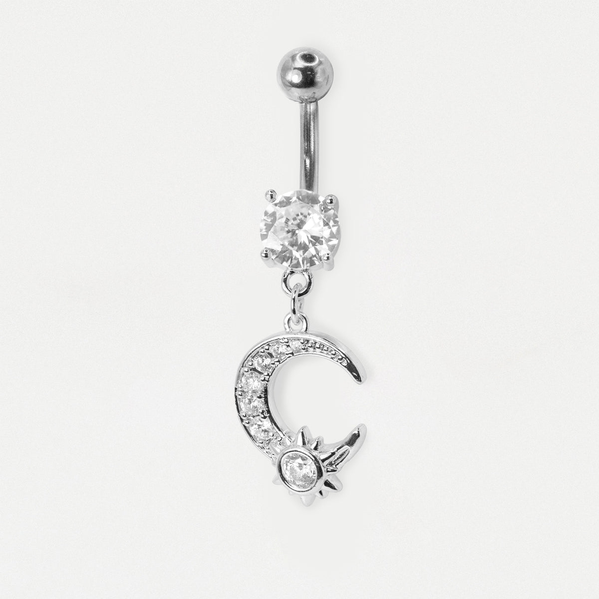 A silver-toned belly button ring featuring a ball top, a clear rhinestone-set oval charm, and a dangling crescent moon and sun charm embellished with small clear stones, shown on a plain light background.