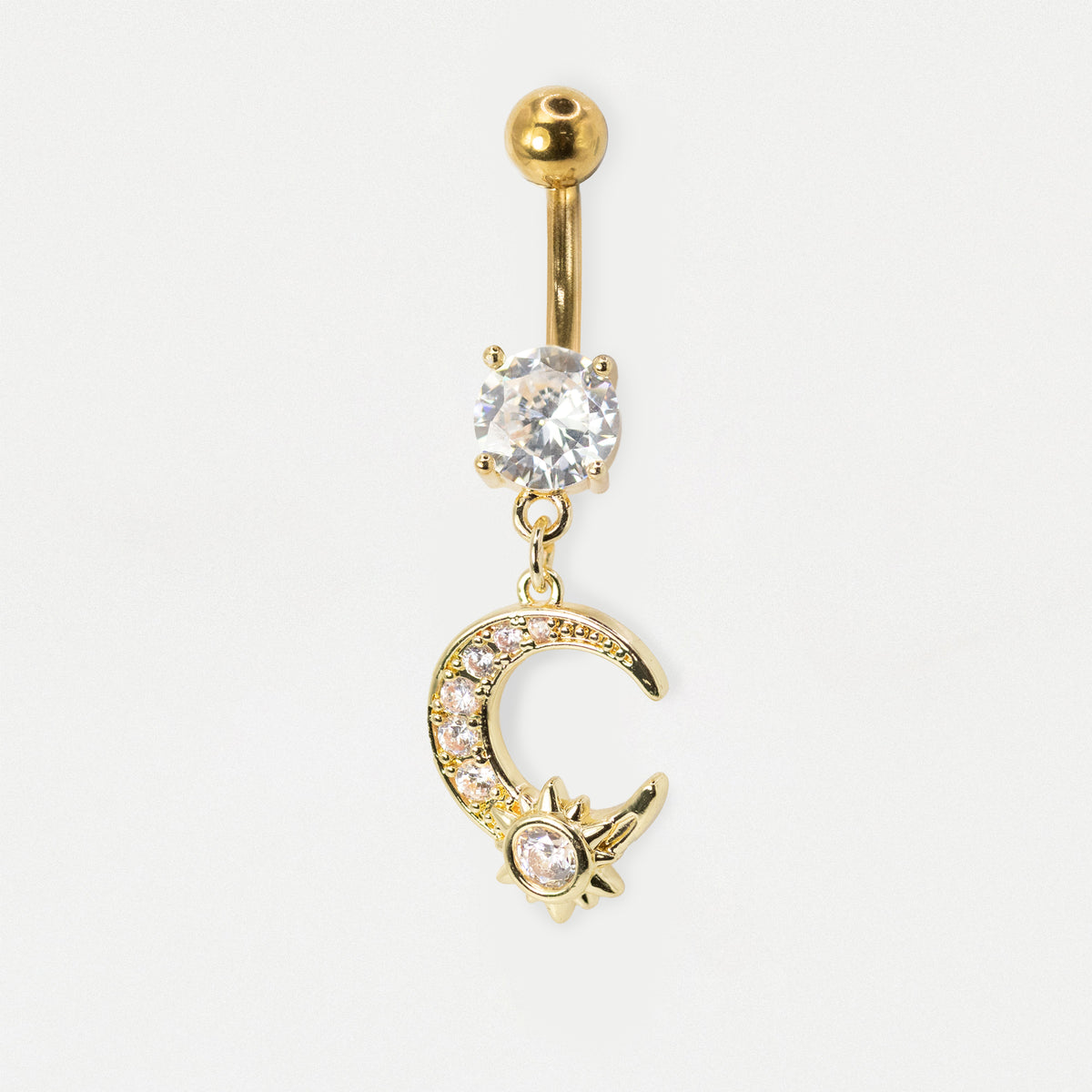 Gold-tone belly button ring with a ball top, a clear rhinestone-set oval charm, and a dangling crescent moon and star charm embellished with small clear stones, on a white background.