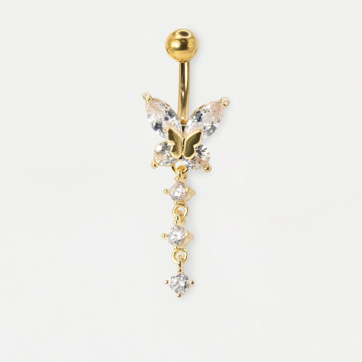 An image of a Gold PVD Steel belly bar with a butterfly design set with clear crystals on a white grey background. 