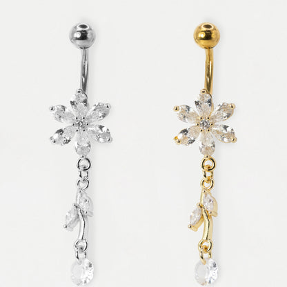 An image showing two belly bars, one in Steel and the other in Gold PVD Steel featuring a six-petal flower set with claw-set clear crystals and a two-marquise leaf dangle by Kingsley Ryan Wholesale