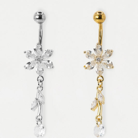 An image showing two belly bars, one in Steel and the other in Gold PVD Steel featuring a six-petal flower set with claw-set clear crystals and a two-marquise leaf dangle by Kingsley Ryan Wholesale