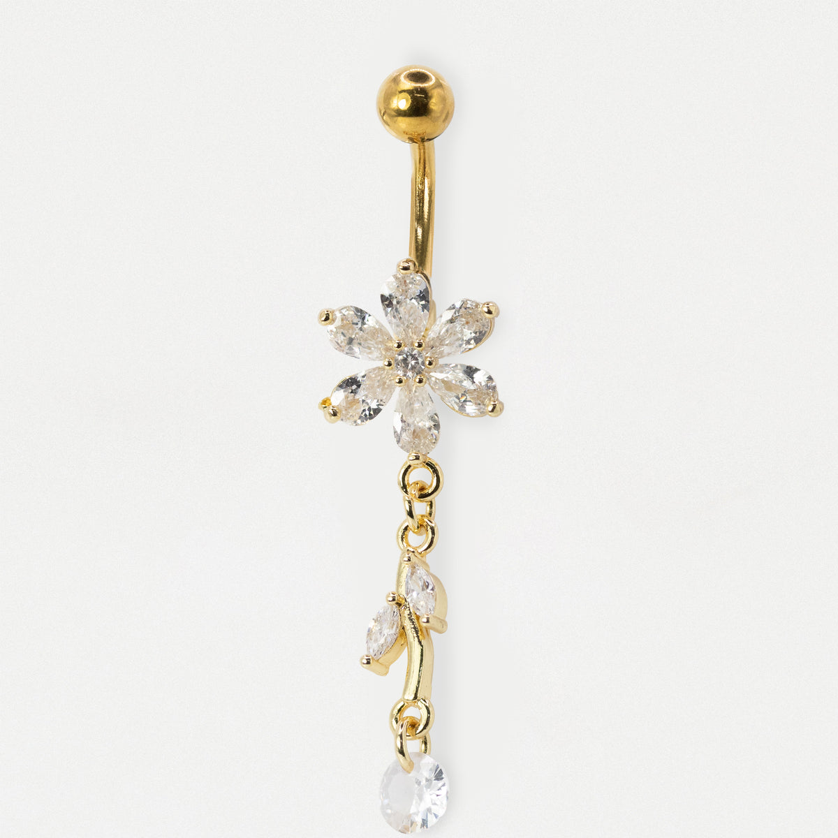 A gold-plated belly button ring featuring a dangling flower and leaf design set with clear, sparkling crystals, shown against a plain white background.