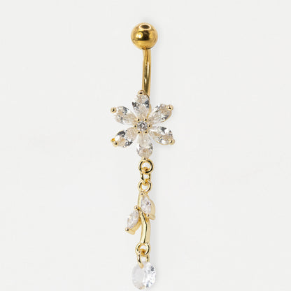 A gold-plated belly button ring featuring a dangling flower and leaf design set with clear, sparkling crystals, shown against a plain white background.