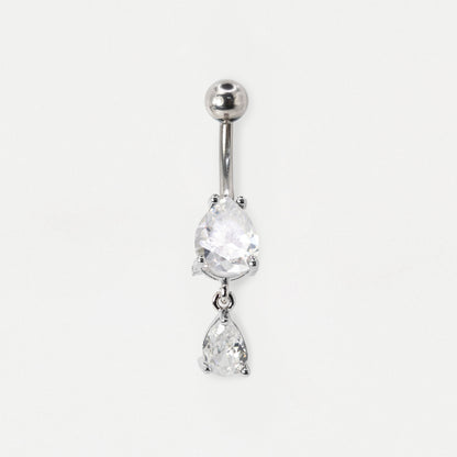 A steel belly button bar featuring two dangling teardrop-shaped clear crystals in a prong setting, by Kingsley Ryan